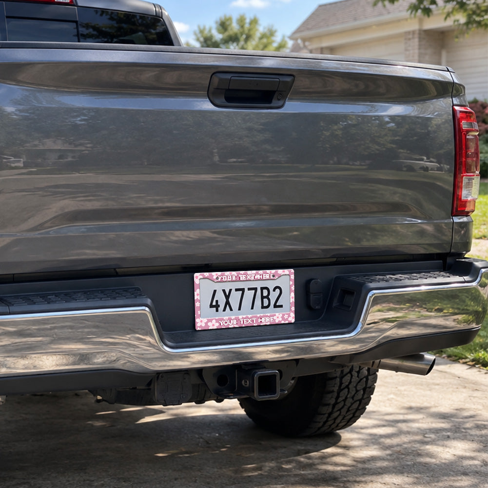 Pink Cherry Blossom license plate frame installed on a pickup truck