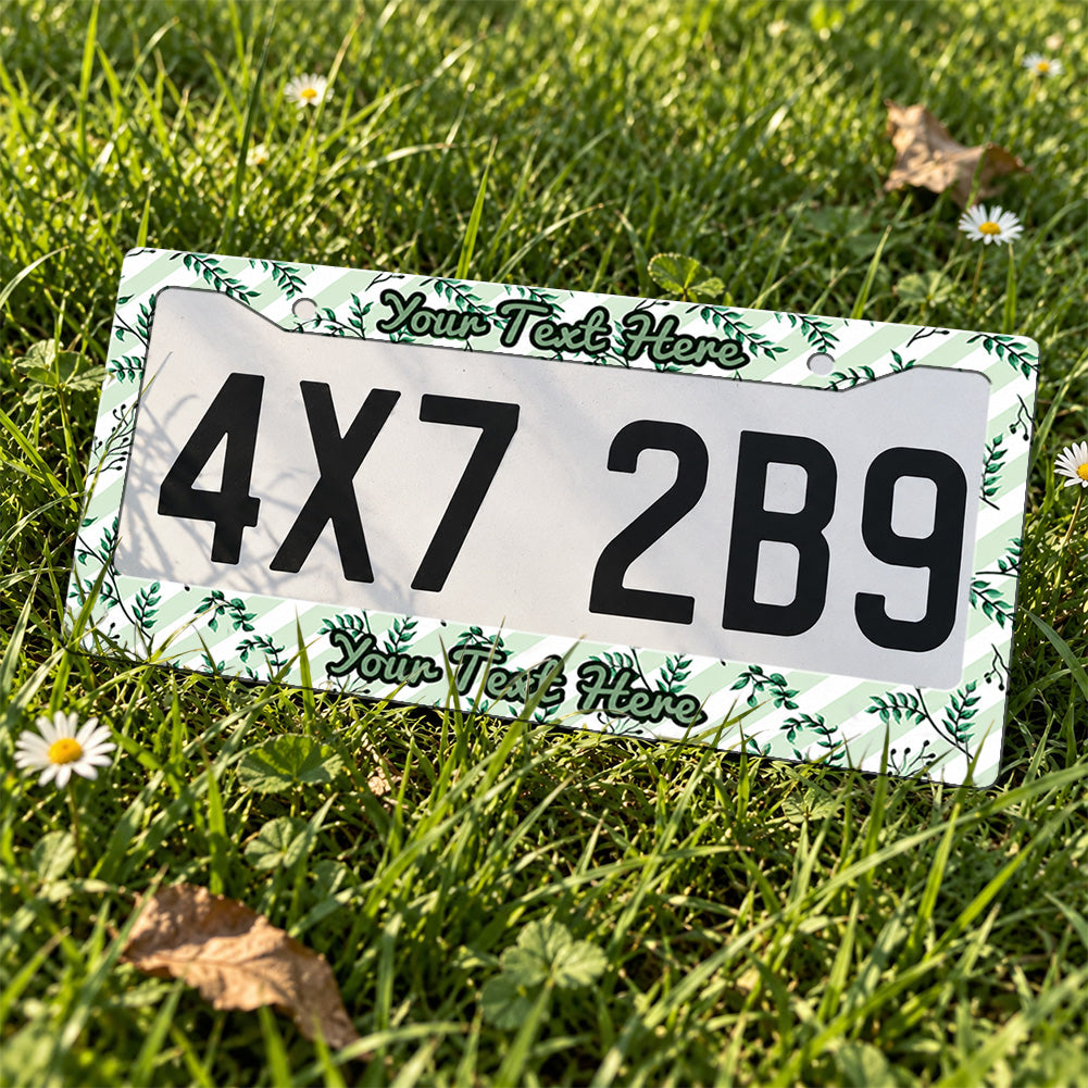 Personalized Green Botanical Leaves license plate frame displayed on a plate outdoors