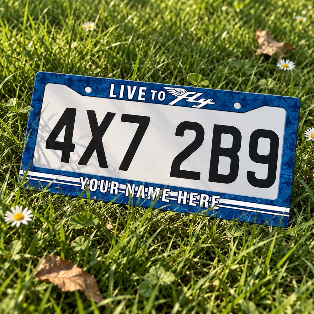 Personalized Live to Fly Aviation license plate frame displayed on a plate outdoors
