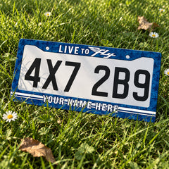 Personalized Live to Fly Aviation license plate frame displayed on a plate outdoors