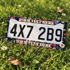 Personalized Dark Botanical Flowers license plate frame displayed on a plate outdoors