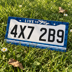 Live to Fly Aviation license plate frame displayed on a plate outdoors