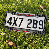 Custom Carbon Fiber Racing license plate frame displayed on a plate outdoors