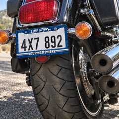 Personalized Live to Fly Aviation license plate frame installed on a motorcycle