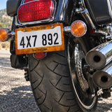 Personalized Rustic Burnt Orange license plate frame installed on a motorcycle
