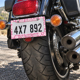 Personalized Pink Cherry Blossom license plate frame installed on a motorcycle