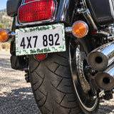 Personalized Green Botanical Leaves license plate frame installed on a motorcycle