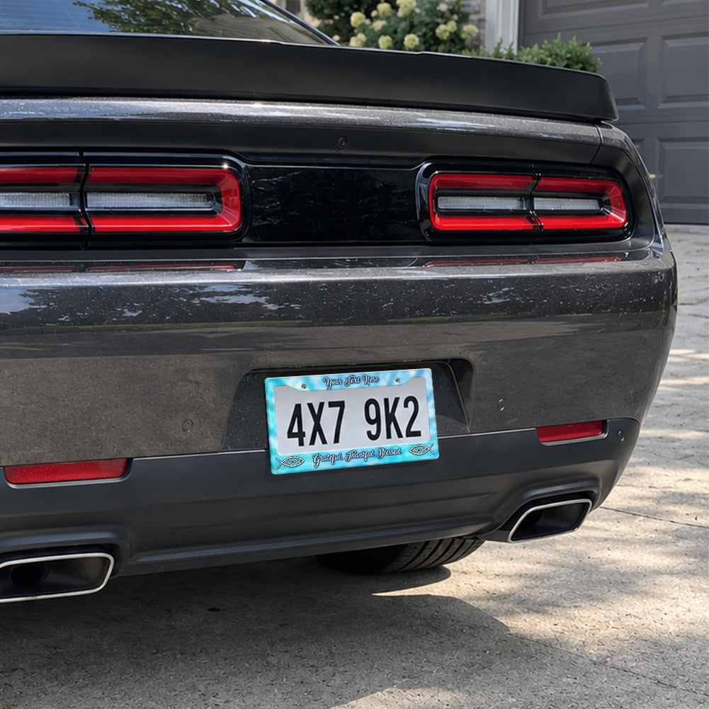 Christian Grateful Thankful Blessed license plate frame installed on a black sports car