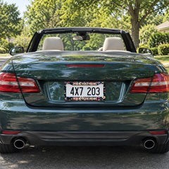 Personalized Dark Botanical Flowers license plate frame installed on a green convertible