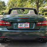 Personalized American Flag license plate frame installed on a green convertible