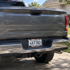 Dark Botanical Flowers license plate frame installed on a pickup truck